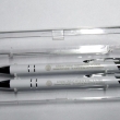 White engraved pens and pencils.